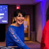 President Mantella smiles shaking a grad's hand